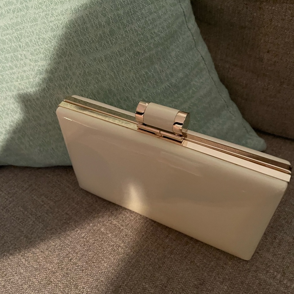 White patent leather and gold clutch
